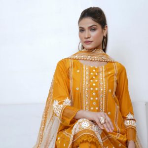 Portrait of a woman in vibrant yellow traditional attire, exuding elegance.