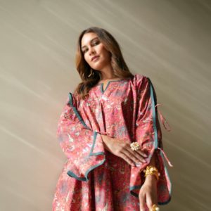 A woman in a pink dress holding a handbag