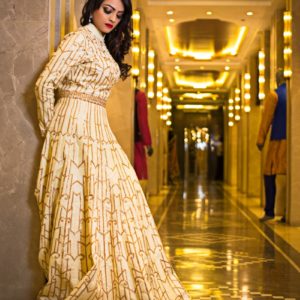 woman in white and brown floral dress standing on hallway